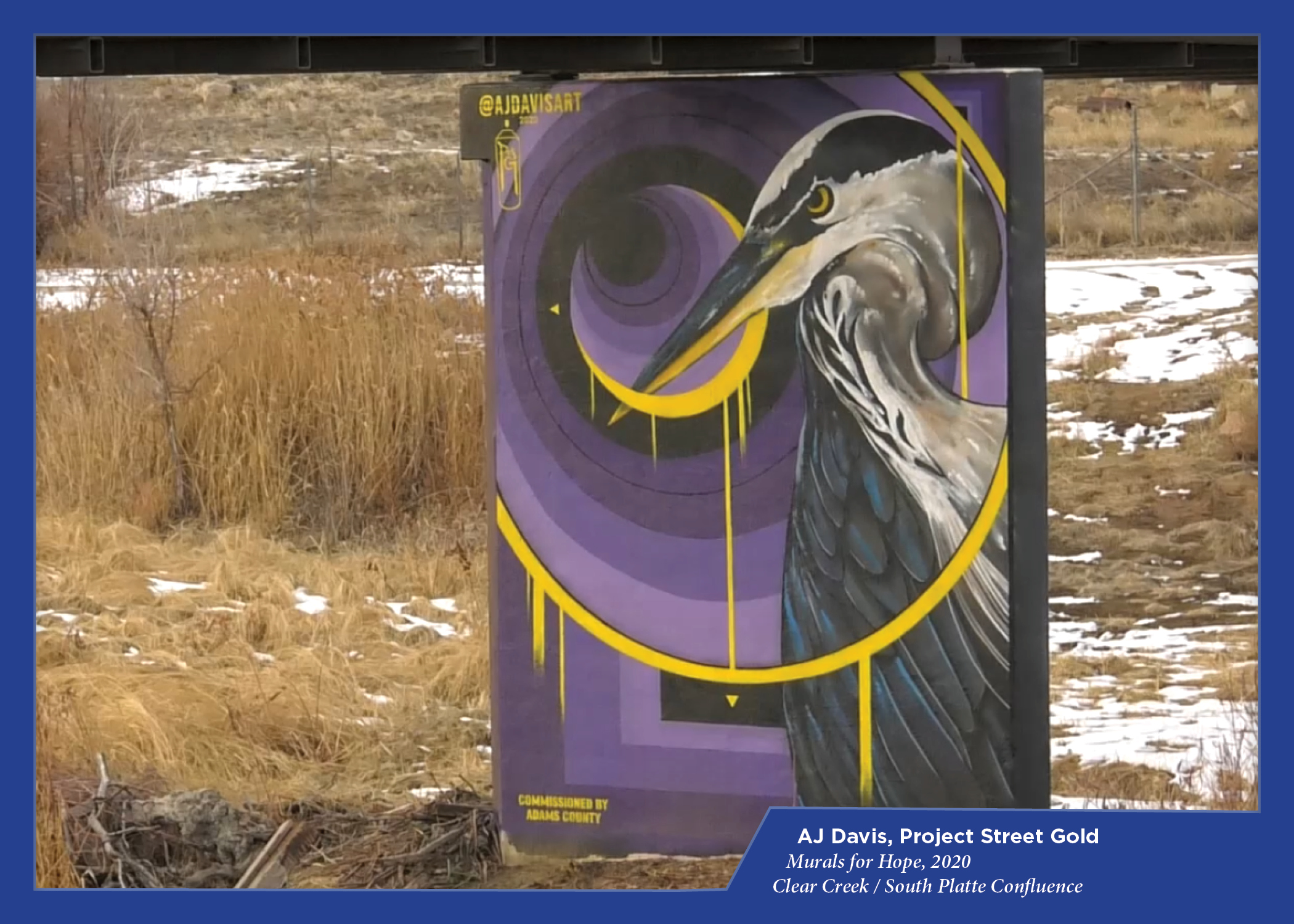 Heron mural by AJ Davis, Project Street Gold; purple and yellow swirling background, snowy landscape.