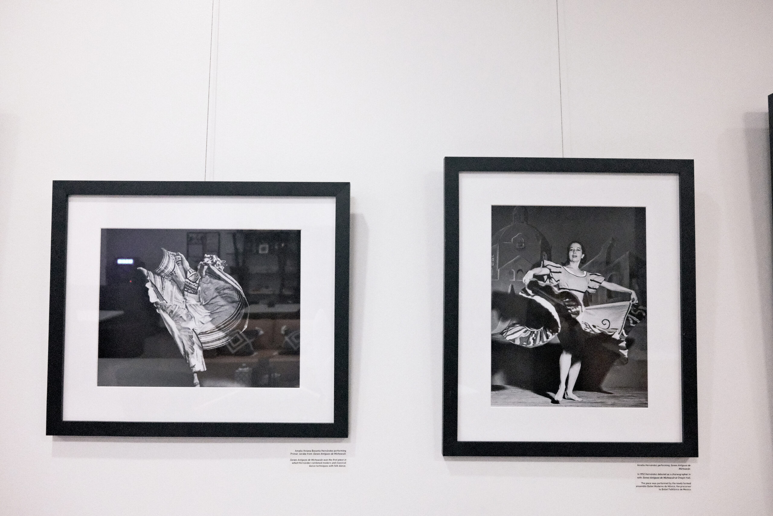 Two black-and-white photos of dancers in mid-performance, each framed in black. Descriptive text displayed below.