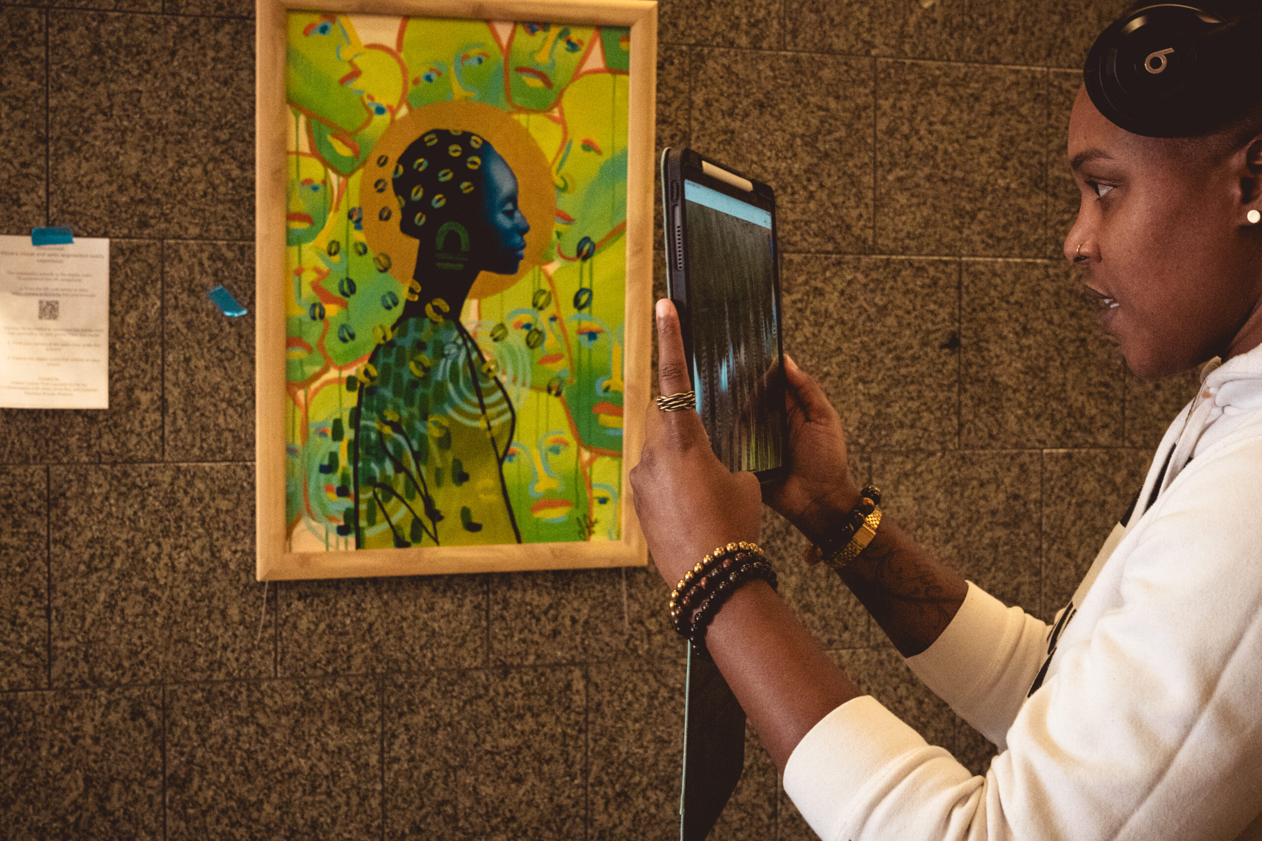 Person in FSR06742.jpg photographing vibrant artwork with a tablet