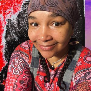 Meca Ayo smiling in a colorful headscarf and patterned shirt, abstract red-black background.