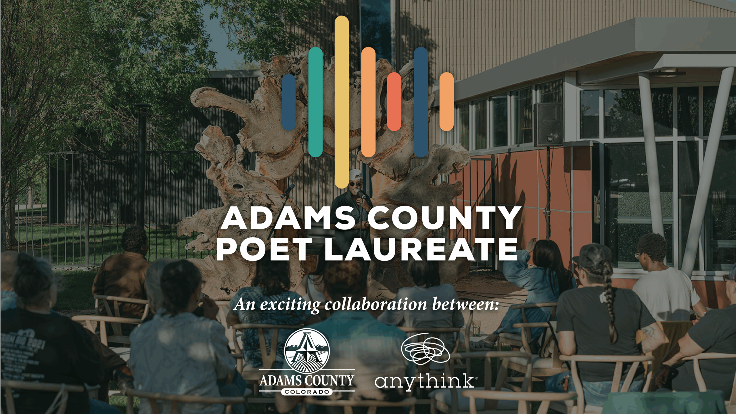 Adams County Poet Laureate event with audience, featuring a collaboration between Adams County Colorado and Anythink libraries.
