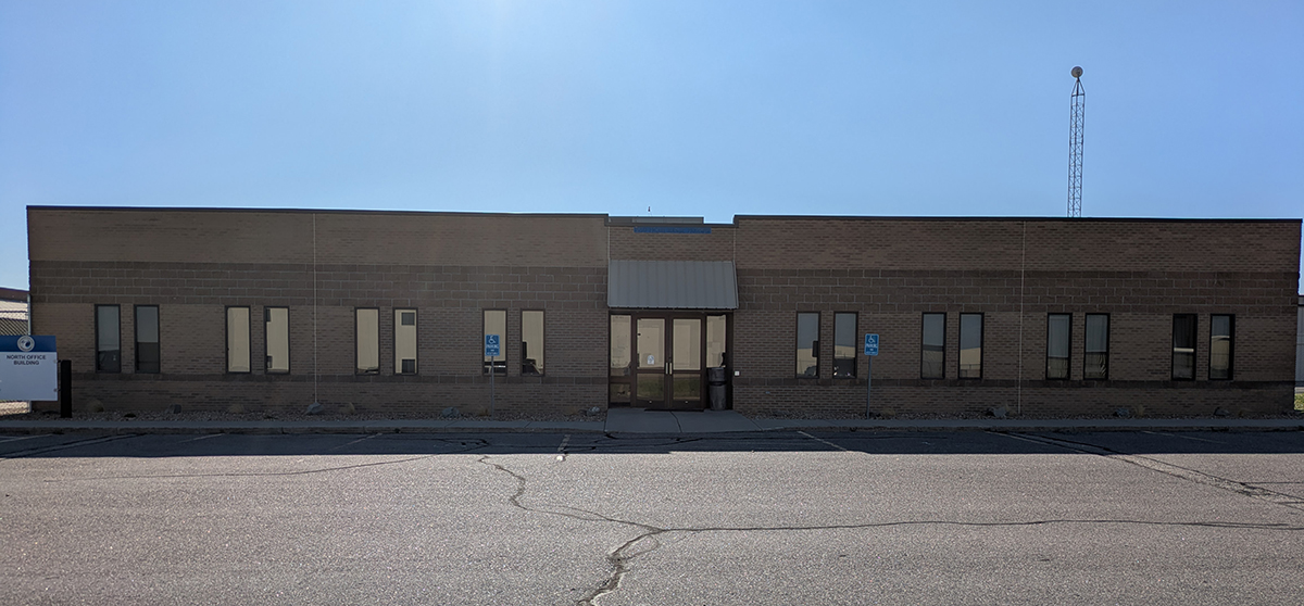 Single-story brick building labeled "North Office Building" with accessible parking signs.