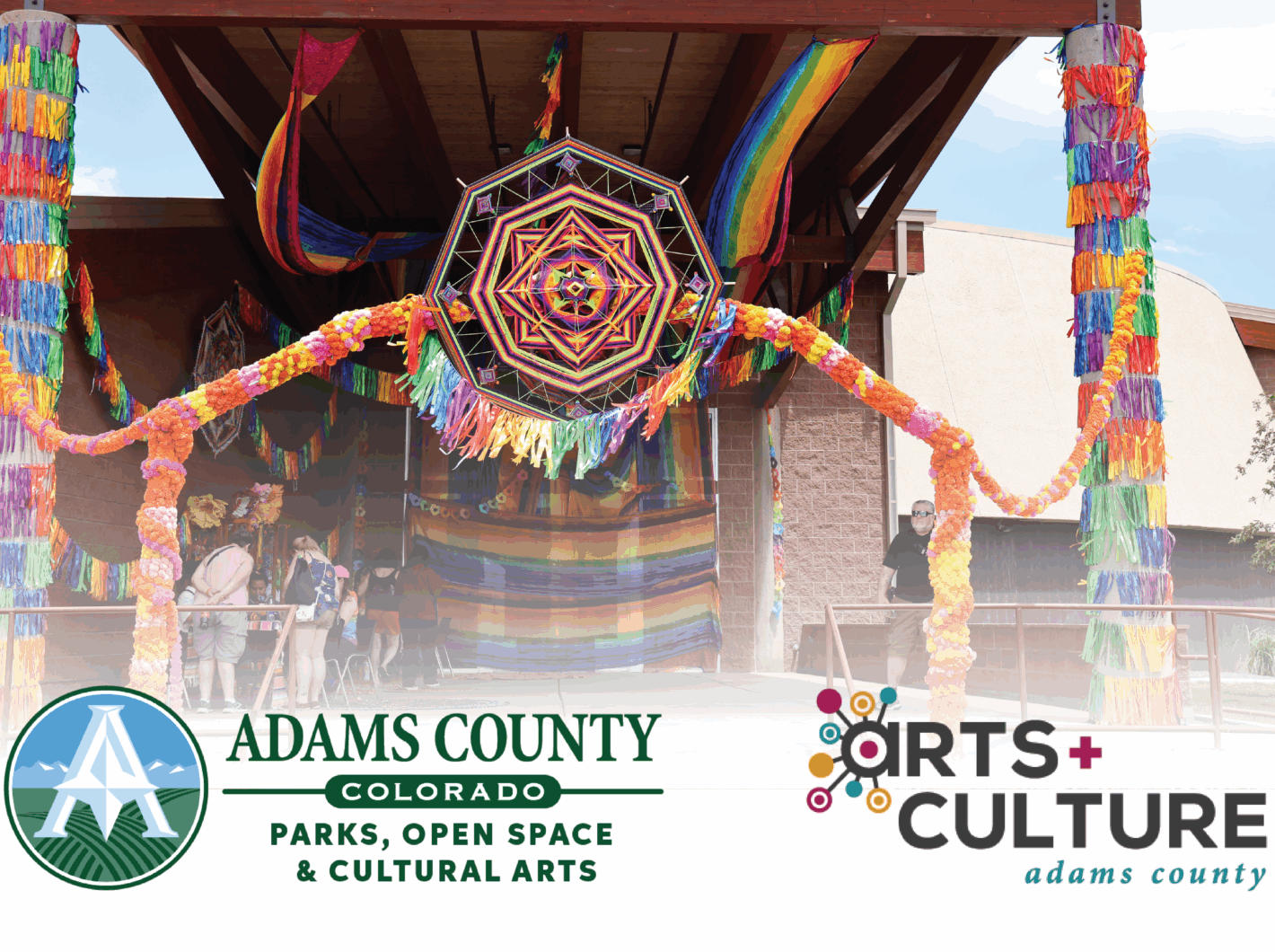 Vibrant fiesta decorations adorn an outdoor venue for Adams County, Colorado cultural event.
