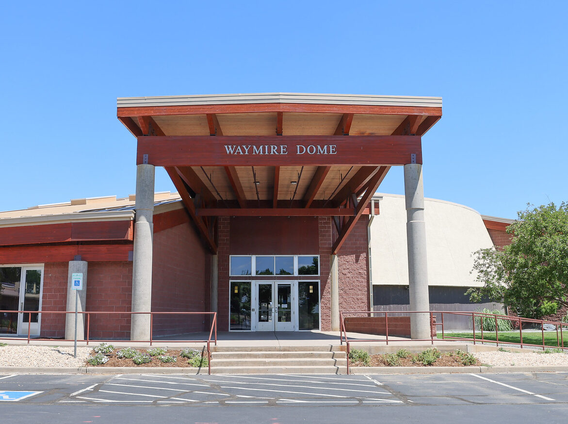 Waymire Dome entrance with red wooden canopy and concrete pillars
