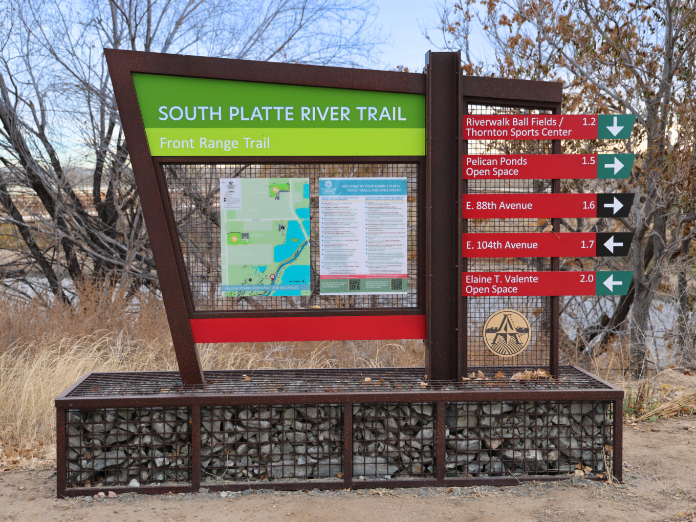 South Platte River Trail sign featuring directions and distances to nearby locations, including parks and avenues