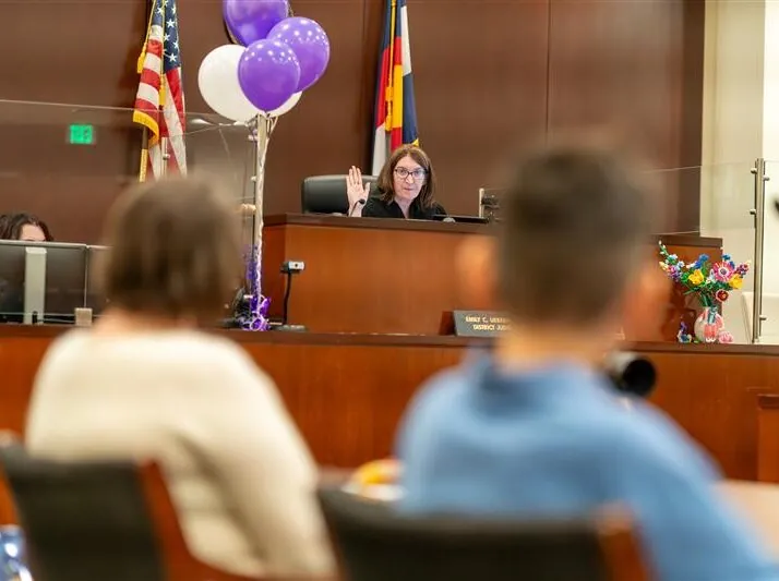 Photo of a judge speaking at National Adoption Day 2025.