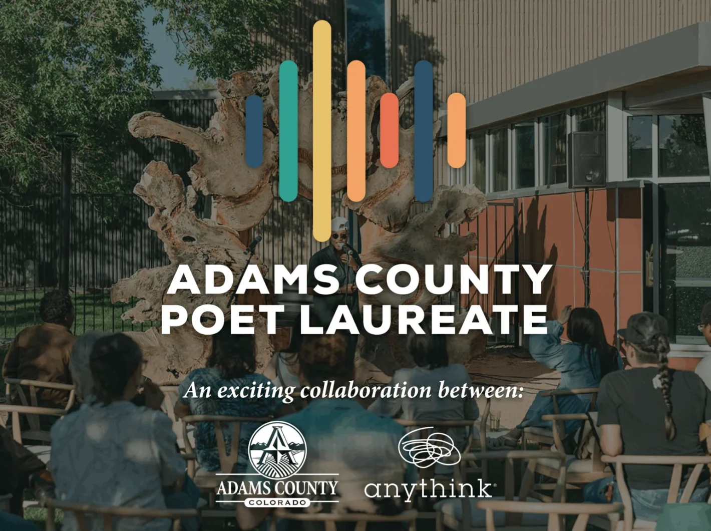 Adams County Poet Laureate event with audience seated outdoors, featuring collaboration between Adams County Colorado and Anythink
