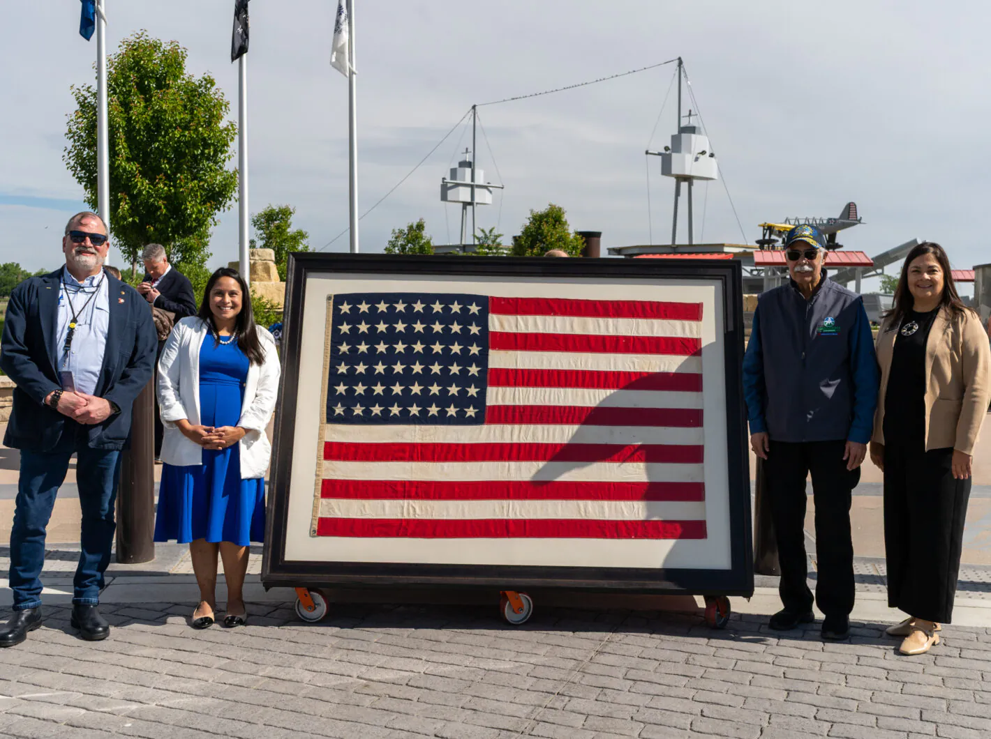 Commissioners posing with flag.