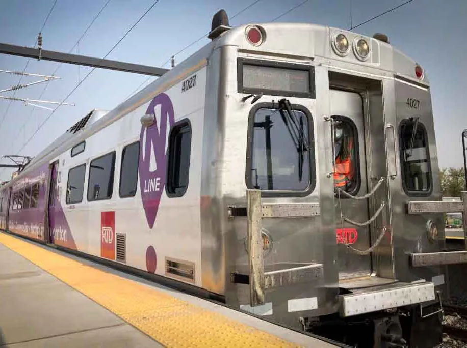 Image of RTD Trail pulling up to the station. Trail is silver.